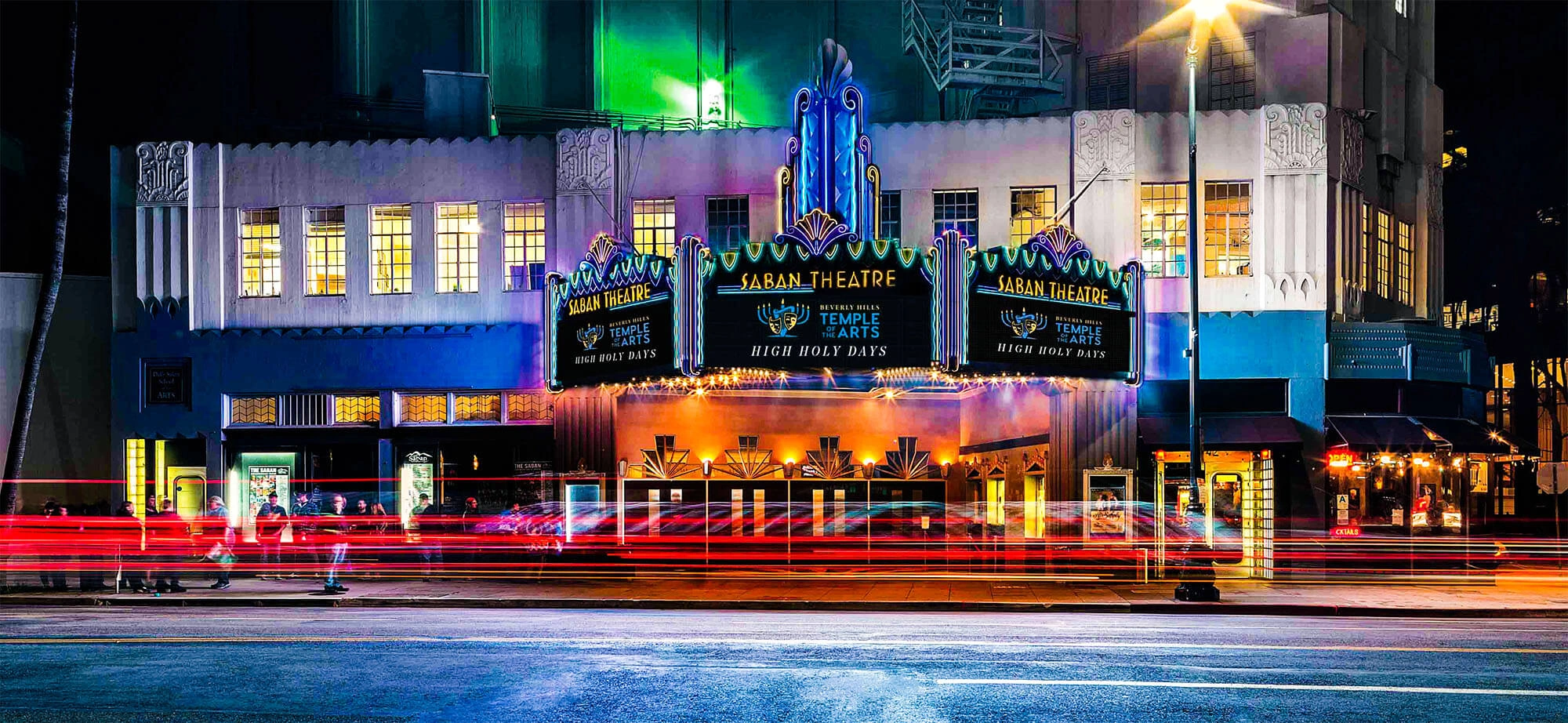 Illuminated Art Deco facade of Saban Theatre in Beverly Hills at night