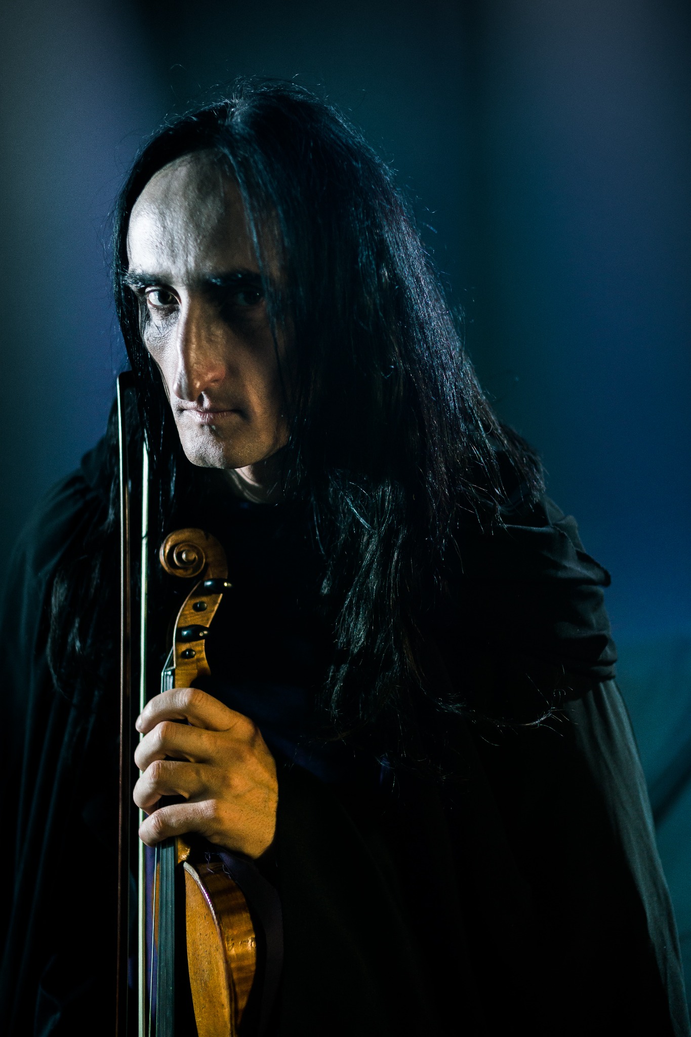 Paganini holding his violin, looking directly toward the viewer