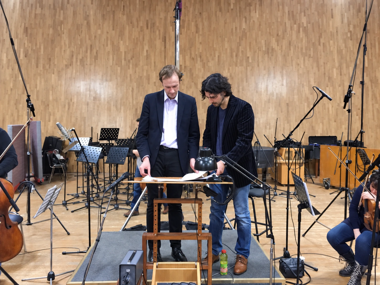 Demitri DARR and a colleague working on the score in a recording room